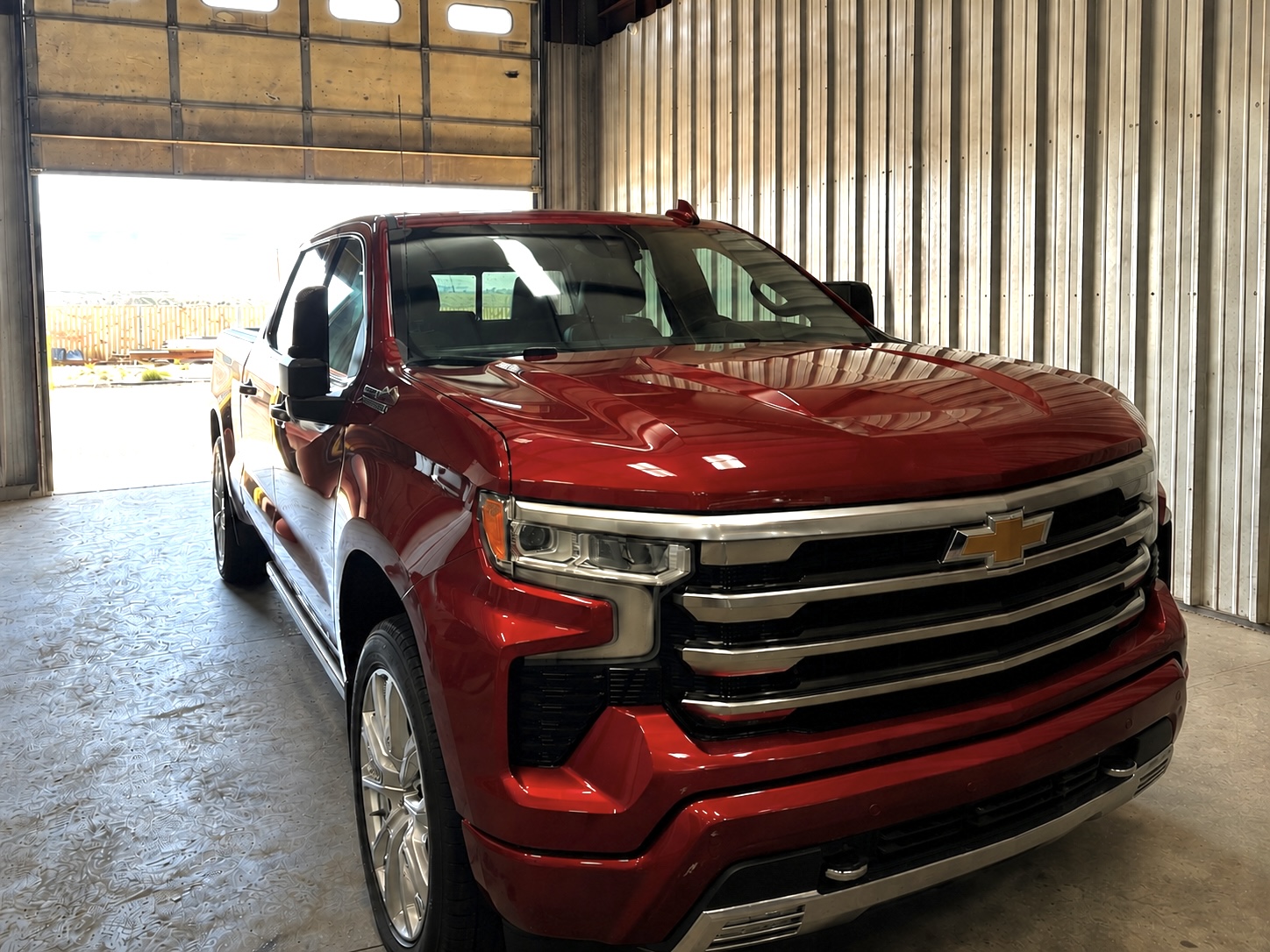Red Chevrolet pickup in a garage, photographed by Fowler’s Finish