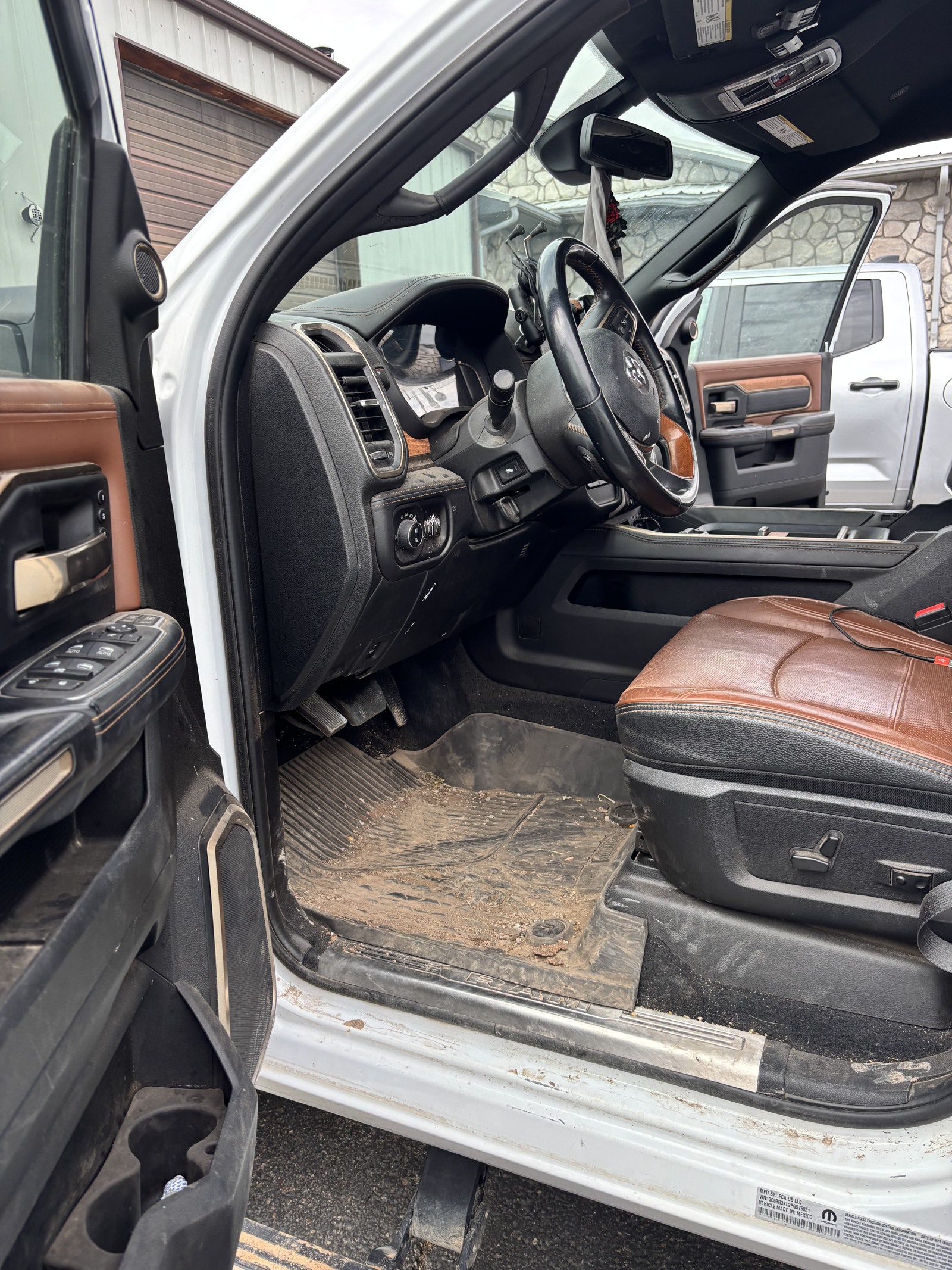 Before detailing: Ram truck interior with dirt on the driver’s floor mat and door sill